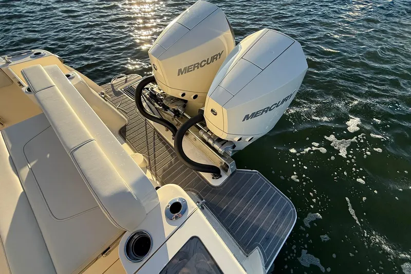Slide: The Image of 2026 Scout 277 Dorado boat with dual Mercury engines on water. - 32
