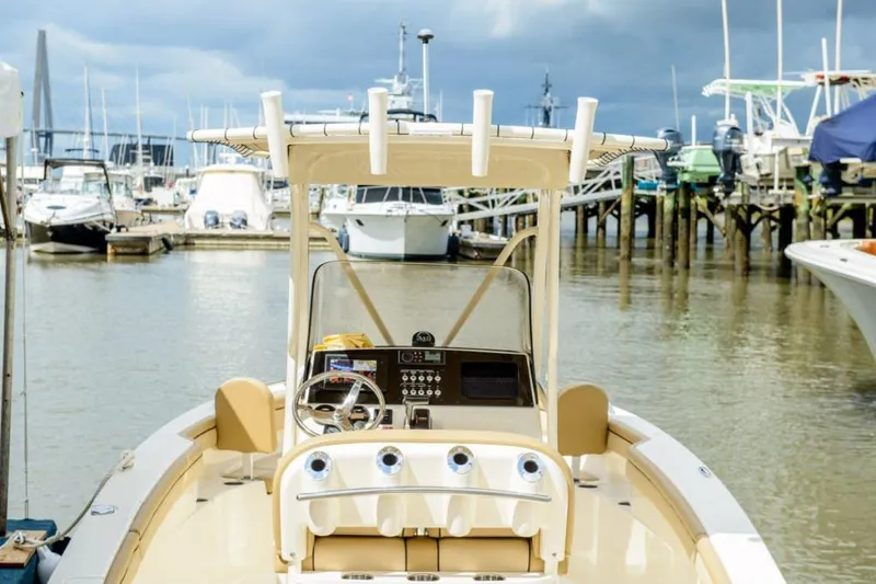 Slide: The Image of 2026 Scout 215 XSF boat interior cabin with control panel and storage space. - 10