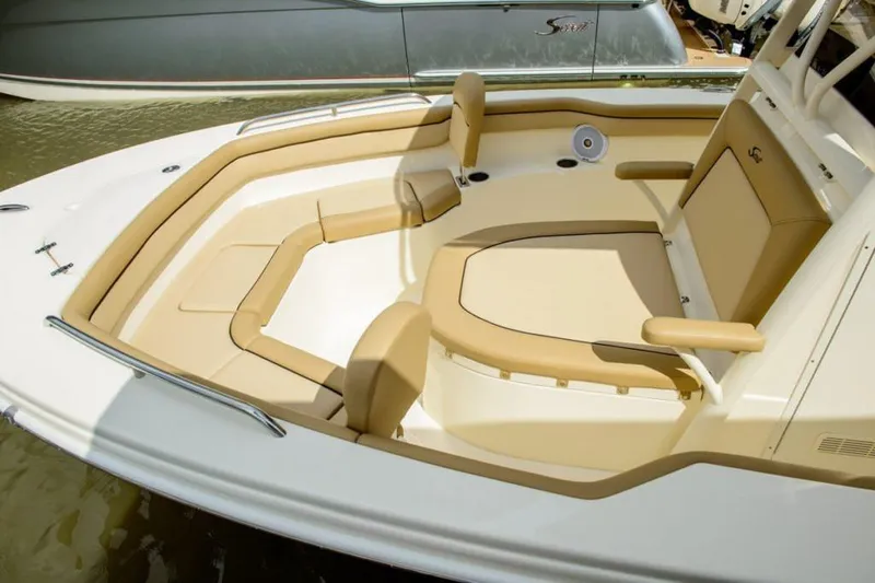 Slide: The Image of 2026 Scout 215 XSF boat interior with cushioned seating and built-in speakers. - 6