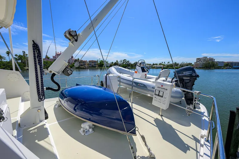 Slide: The Image of 2013 Krogen 44' AE Widebody yacht deck with inflatable boat and clear blue sky. - 34