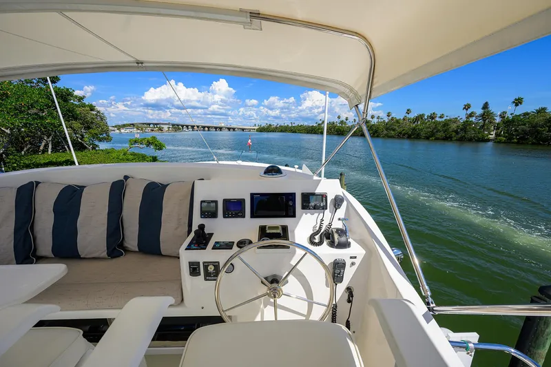 Slide: The Image of Flybridge view of 2013 Krogen 44' AE Widebody yacht cruising on a scenic river. - 37