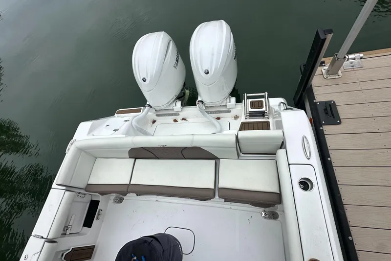 Slide: The Image of 2025 Tidewater 256 LXF boat with dual engines docked at a marina. - 5