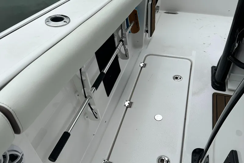 Slide: The Image of 2025 Tidewater 256 LXF boat interior with rod holder and storage compartment. - 6