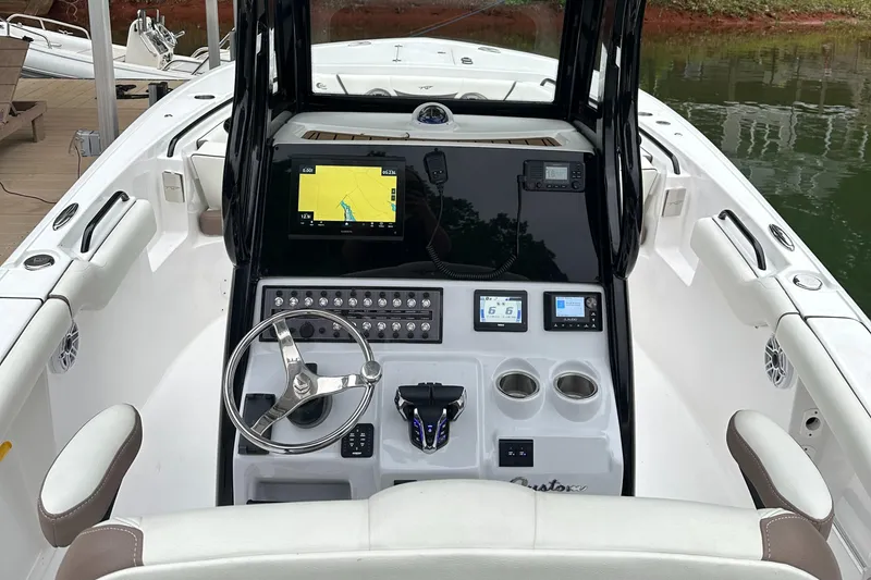 Slide: The Image of 2025 Tidewater 256 LXF boat dashboard with navigation screen and controls. - 9