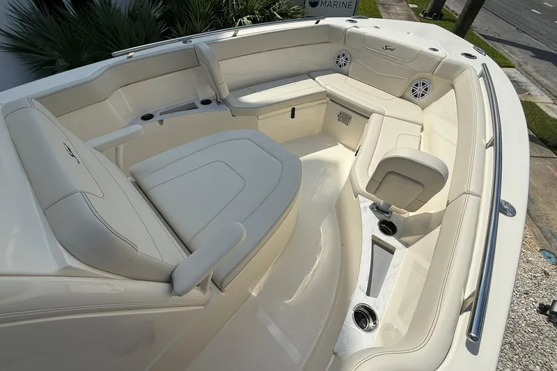 Slide: The Image of Luxurious seating area on 2026 Scout 240 XSF boat with cup holders and speakers. - 10