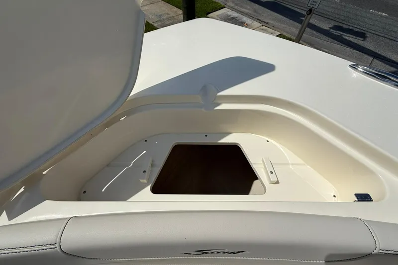 Slide: The Image of Open storage compartment on 2026 Scout 240 XSF boat, showcasing interior space. - 13