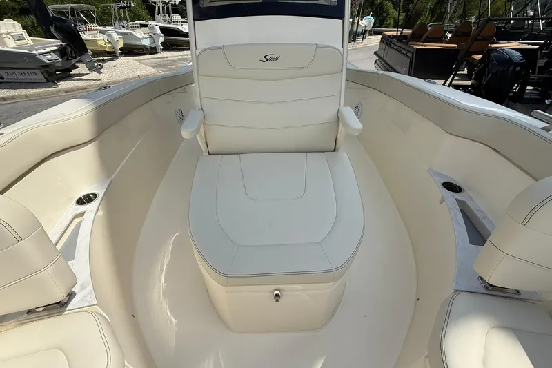 Slide: The Image of 2026 Scout 240 XSF boat interior with white seating and cup holders. - 16