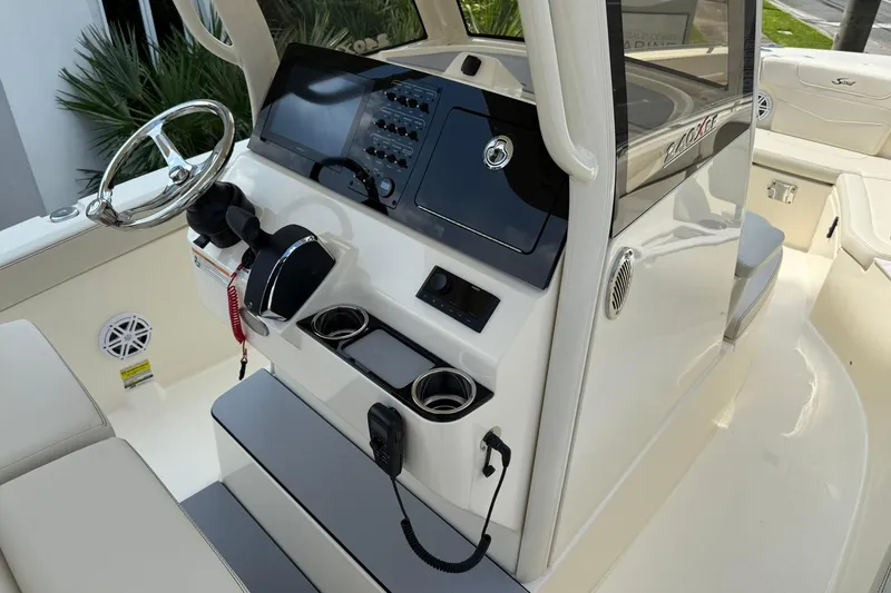 Slide: The Image of 2026 Scout 240 XSF boat dashboard with steering wheel and control panel. - 19