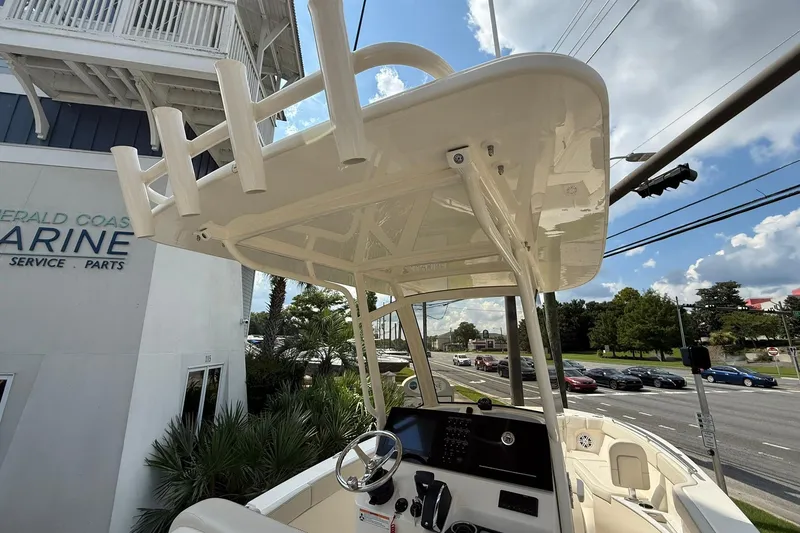 Slide: The Image of 2026 Scout 240 XSF boat at Emerald Coast Marine dealership, showcasing helm and T-top. - 24