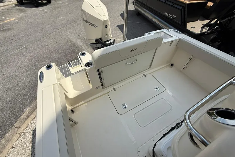Slide: The Image of 2026 Scout 240 XSF boat interior with Mercury engine, featuring spacious deck and seating. - 26