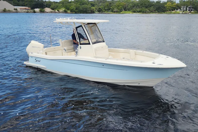 Slide: The Image of 2026 Scout 240 XSF boat cruising on a calm lake with scenic background. - 3