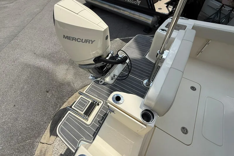 Slide: The Image of 2026 Scout 240 XSF boat with Mercury outboard engine, featuring sleek deck design. - 31
