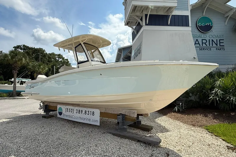 Slide: The Image of 2026 Scout 240 XSF boat displayed at Emerald Coast Marine dealership. - 4