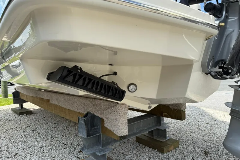 Slide: The Image of 2026 Scout 240 XSF boat hull on support, showcasing sleek design and modern features. - 9