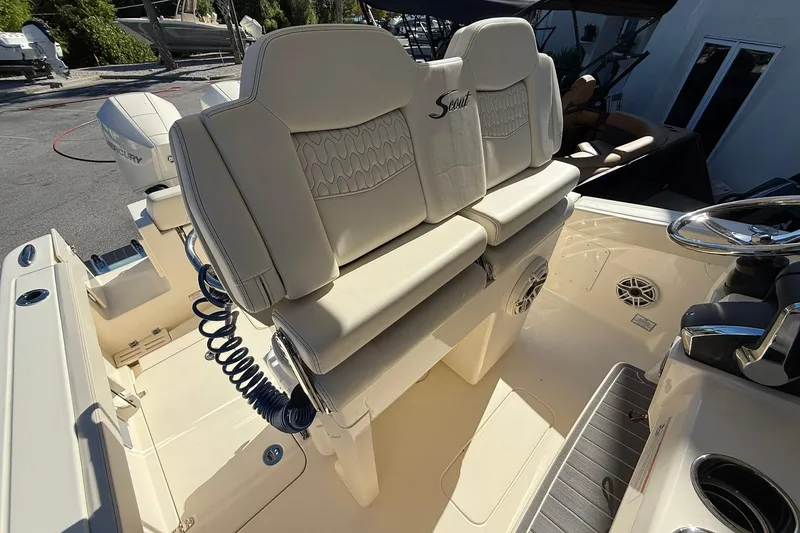 Slide: The Image of 2026 Scout 260 LXF boat interior with beige seating and steering wheel. - 16