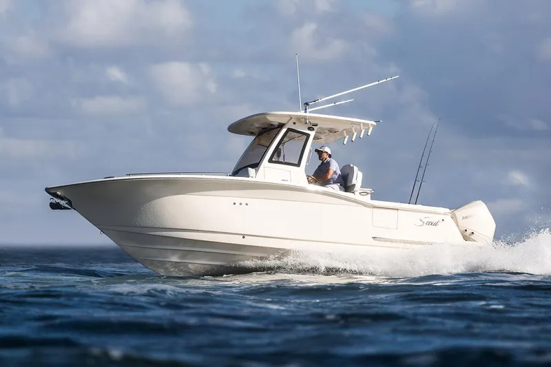 Slide: The Image of 2026 Scout 260 LXF boat with dual 200 V6 engines on a sunny street. - 2