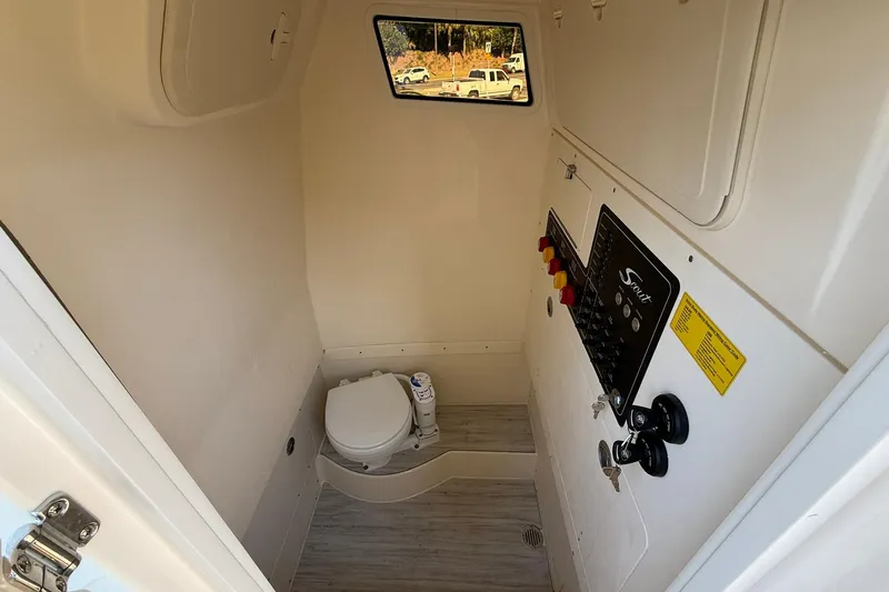 Slide: The Image of 2026 Scout 260 LXF boat interior with compact bathroom and control panel. - 21