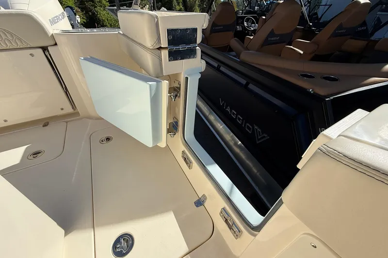 Slide: The Image of 2026 Scout 260 LXF boat interior with open storage compartment and seating. - 24