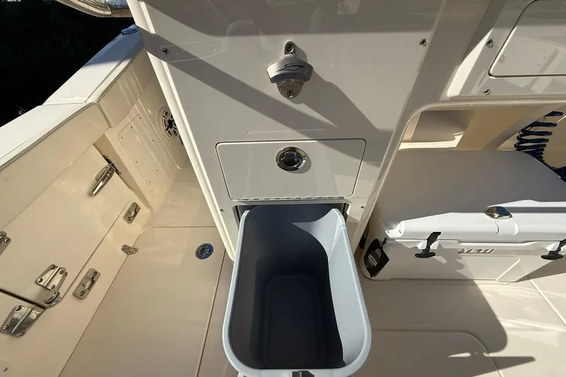 Slide: The Image of Interior view of 2026 Scout 260 LXF boat featuring storage compartments and cooler. - 28