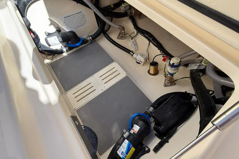 Slide: The Image of 2026 Scout 260 LXF boat interior showing mechanical components and wiring. - 34