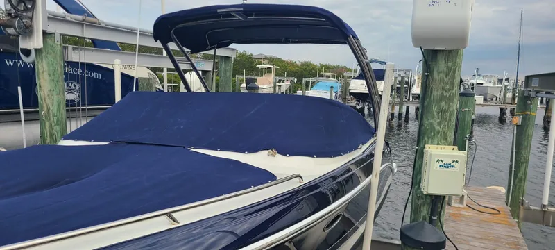 Slide: The Image of 2018 Formula 270 Bowrider boat docked with blue cover in marina. - 1