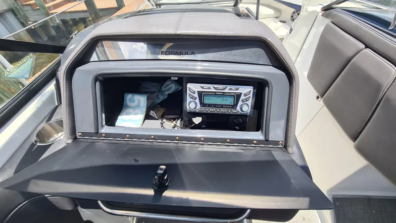 Slide: The Image of 2018 Formula 270 Bowrider dashboard with stereo system and storage compartment. - 13