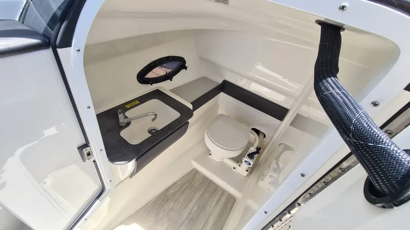 Slide: The Image of 2018 Formula 270 Bowrider boat interior with compact bathroom, sink, and toilet. - 14
