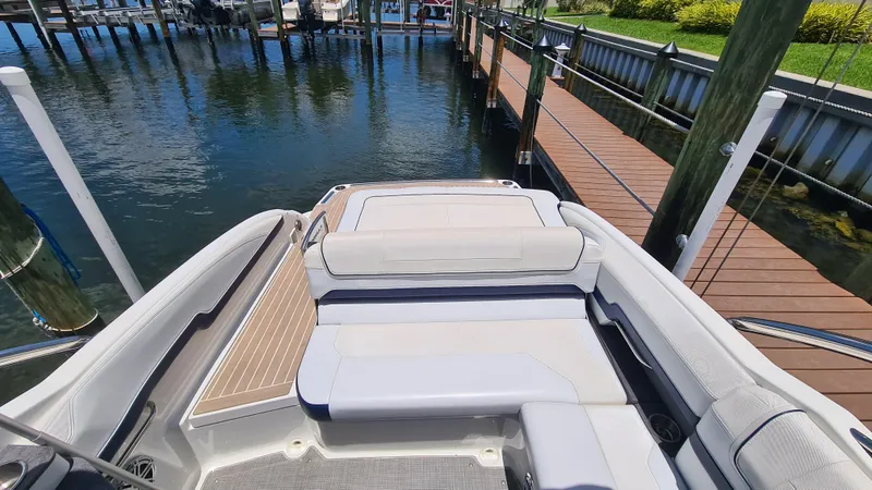 Slide: The Image of 2018 Formula 270 Bowrider boat docked, featuring spacious seating and sleek design. - 16