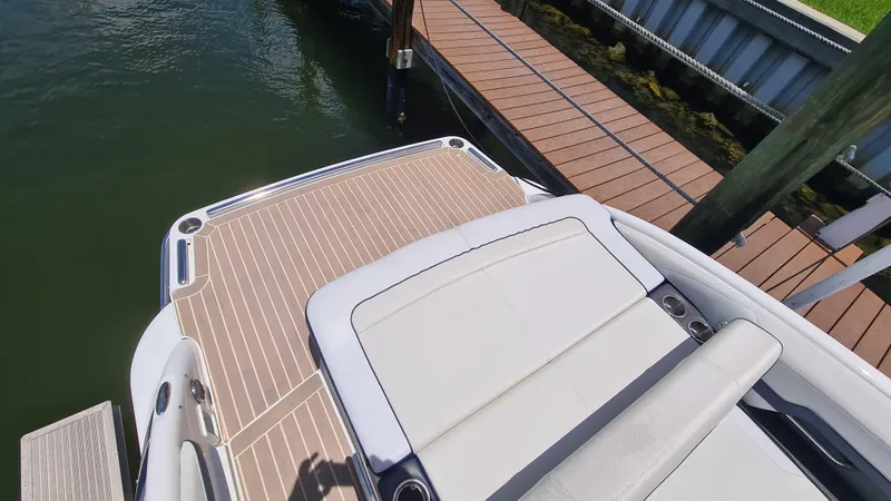 Slide: The Image of 2018 Formula 270 Bowrider boat docked, featuring a spacious swim platform and sleek design. - 21