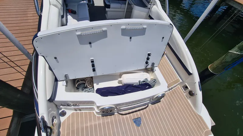 Slide: The Image of 2018 Formula 270 Bowrider boat with open storage compartment, docked by wooden pier. - 23