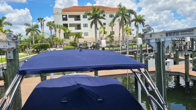 Slide: The Image of 2018 Formula 270 Bowrider docked at marina with palm trees and building in background. - 25