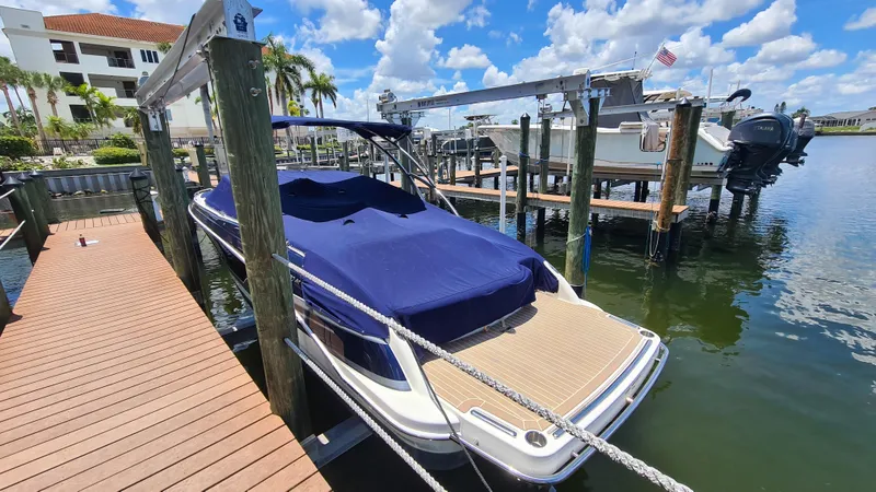 Slide: The Image of 2018 Formula 270 Bowrider docked with blue cover, sunny day, palm trees in background. - 3