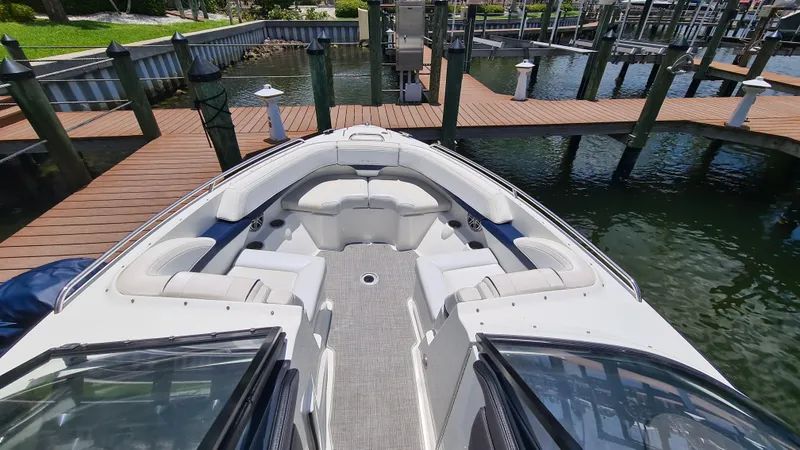 Slide: The Image of 2018 Formula 270 Bowrider boat docked, featuring spacious seating and sleek design. - 5