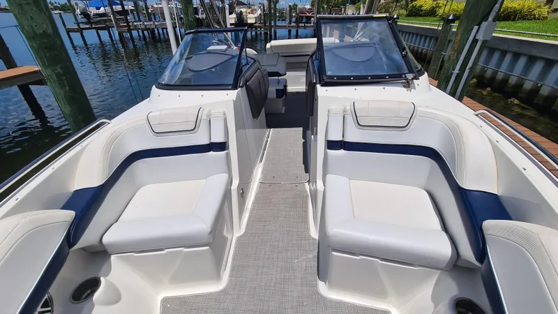 Slide: The Image of 2018 Formula 270 Bowrider interior with white seating, docked by the water. - 7