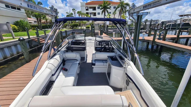Slide: The Image of 2018 Formula 270 Bowrider boat docked, featuring spacious seating and sleek design. - 8