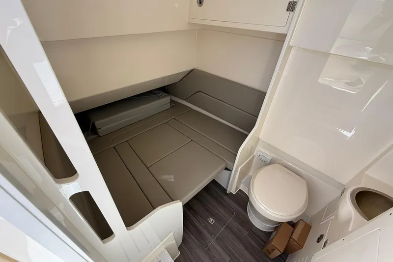 Slide: The Image of 2026 Scout 330 LXF cabin interior with seating and compact toilet. - 15