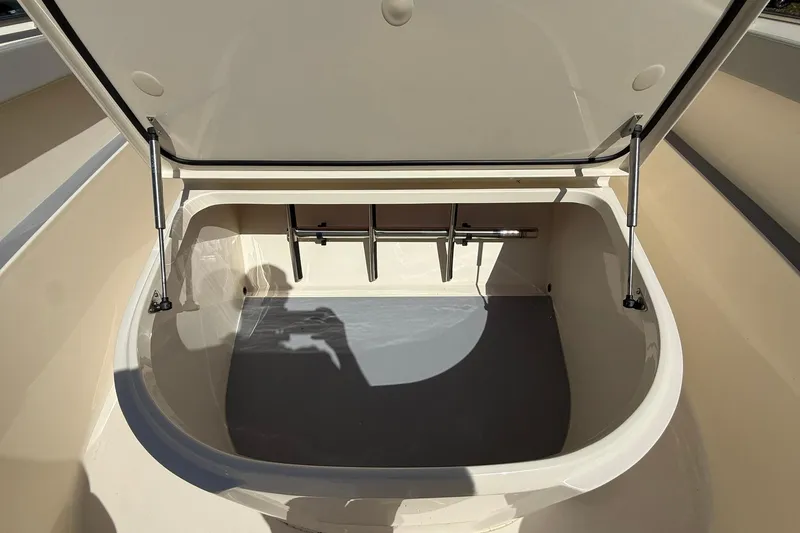 Slide: The Image of Open storage compartment on 2026 Scout 330 LXF boat, showcasing spacious interior. - 17