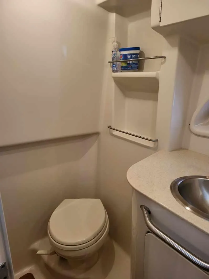 Slide: The Image of Compact bathroom in 2009 Sea Ray 310 Sundancer yacht with toilet and sink. - 15