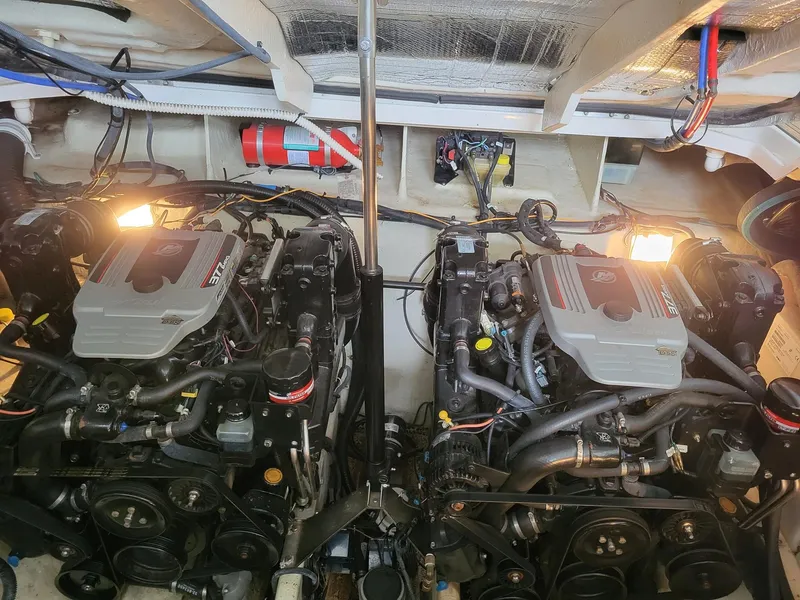 Slide: The Image of Engine room of a 2009 Sea Ray 310 Sundancer with dual engines and visible wiring. - 5