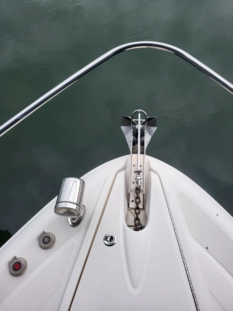 Slide: The Image of Bow of 2009 Sea Ray 310 Sundancer with anchor and railing over water. - 8