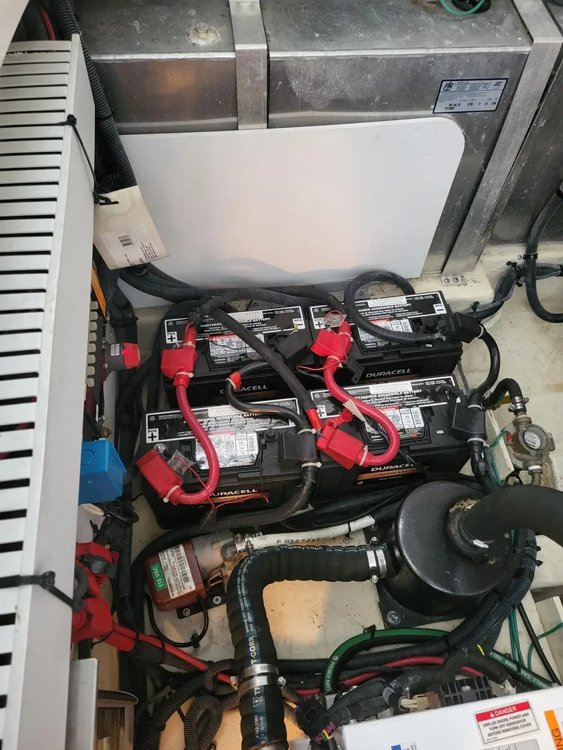 Slide: The Image of 2009 Sea Ray 310 Sundancer engine compartment with Duracell batteries and wiring. - 9