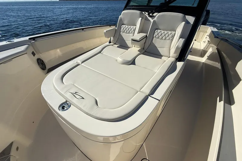 Slide: The Image of Luxurious seating on 2026 Scout 357 LXF boat, featuring elegant white upholstery. - 11