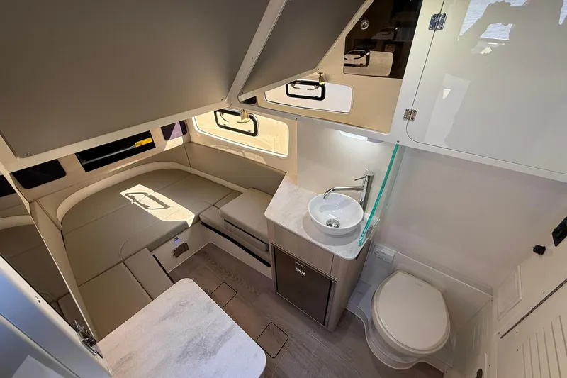 Slide: The Image of 2026 Scout 357 LXF cabin interior with seating, sink, and toilet. - 15
