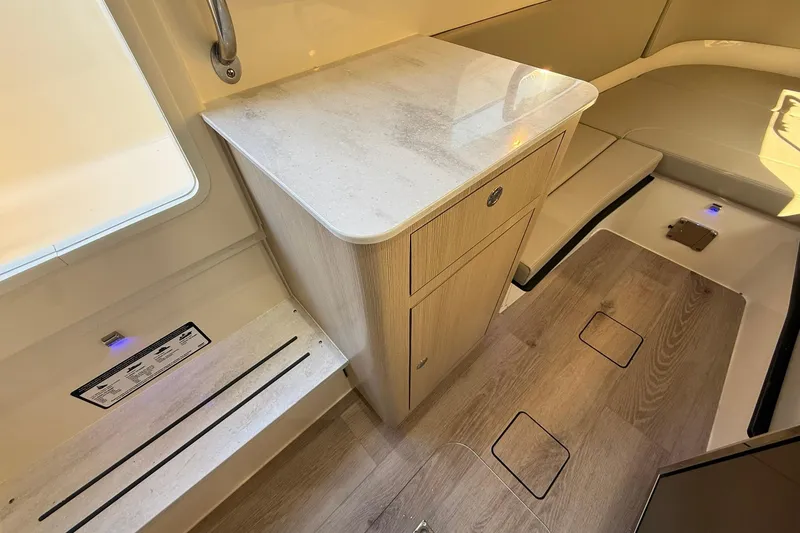 Slide: The Image of 2026 Scout 357 LXF interior with wood flooring and compact cabinetry. - 17