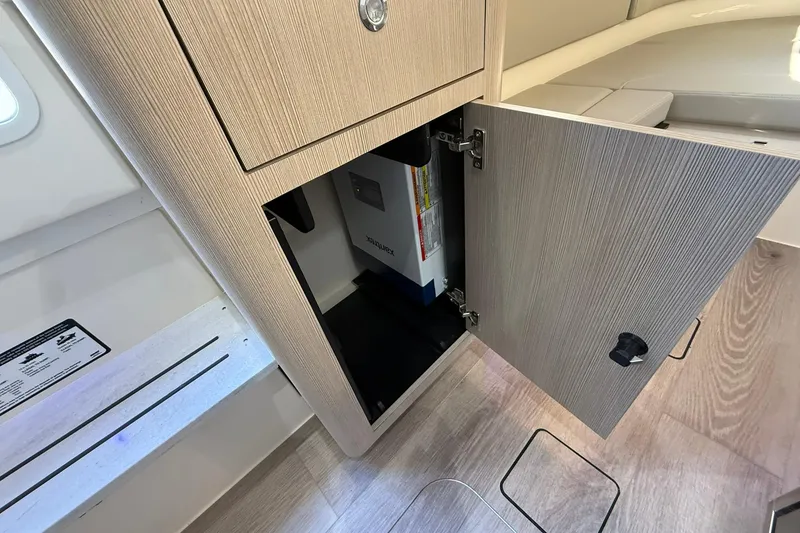Slide: The Image of 2026 Scout 357 LXF interior storage compartment with open cabinet door. - 19