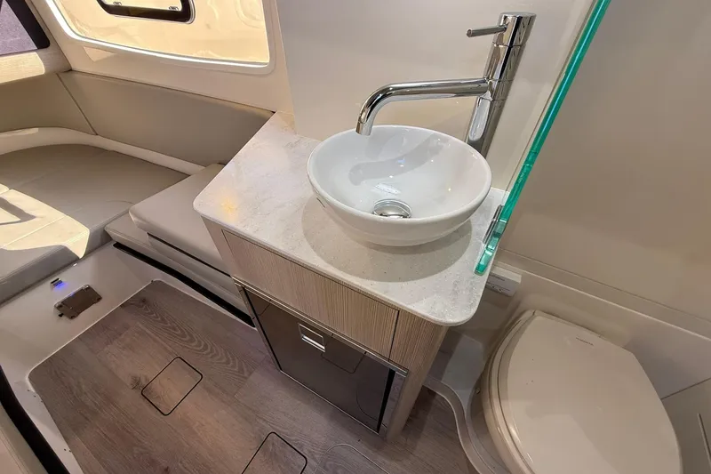 Slide: The Image of 2026 Scout 357 LXF boat interior with modern sink and seating area. - 20