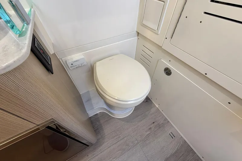 Slide: The Image of 2026 Scout 357 LXF boat bathroom interior with modern toilet and sleek design. - 21