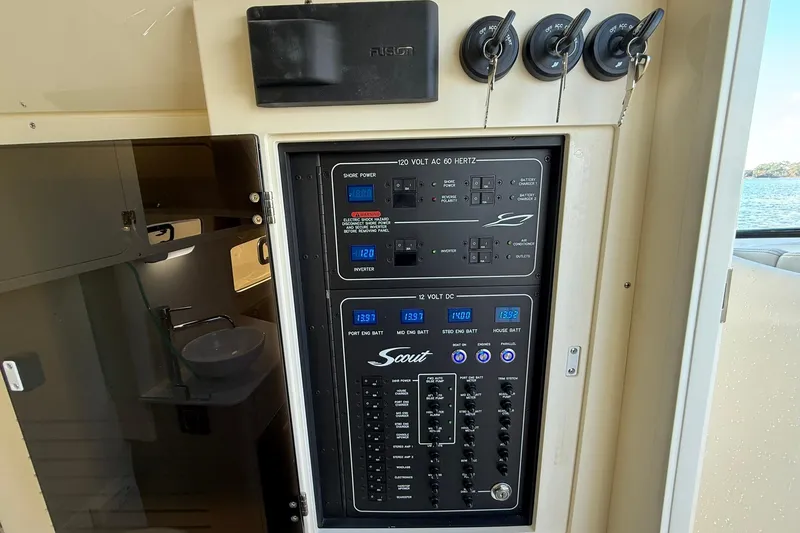 Slide: The Image of Electrical control panel on 2026 Scout 357 LXF boat, featuring various switches and displays. - 22