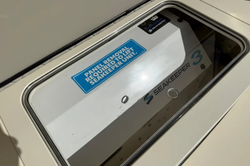 Slide: The Image of Seakeeper 3 unit panel on 2026 Scout 357 LXF boat, requiring removal for access. - 32