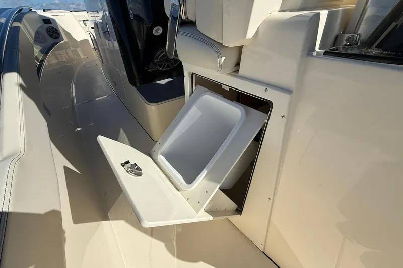 Slide: The Image of 2026 Scout 357 LXF boat interior with open storage compartment. - 33